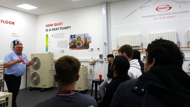 Students from New College Swindon listen to a training session at Grant UK