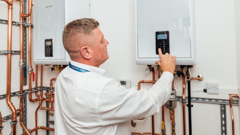 A Navien installer working on a boiler